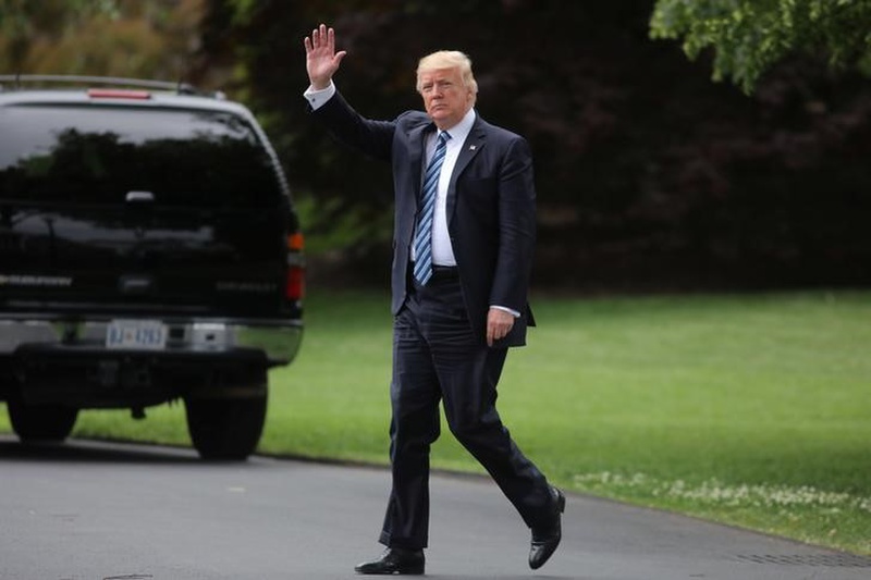 U.S. President Donald Trump waves as he leaves the Oval Office of the White House in Washington U.S. before his departure to New York May