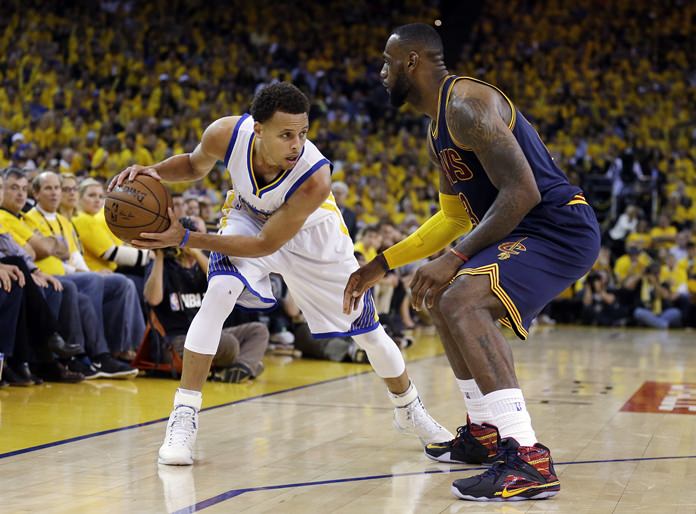 Golden State Warriors guard Stephen Curry left is challenged by Cleveland Cavaliers forward Le Bron James in this