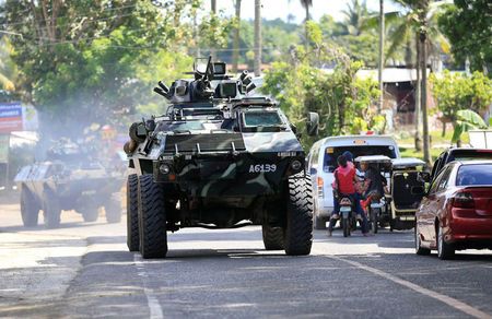 An armoured personnel carrier belonging to government troops drives along a main highway of Pantar town Lanao Del Norte as it travels to reinforce Marawi city southern Philippines