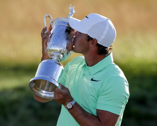 Brooks Koepka kisses the winning trophy