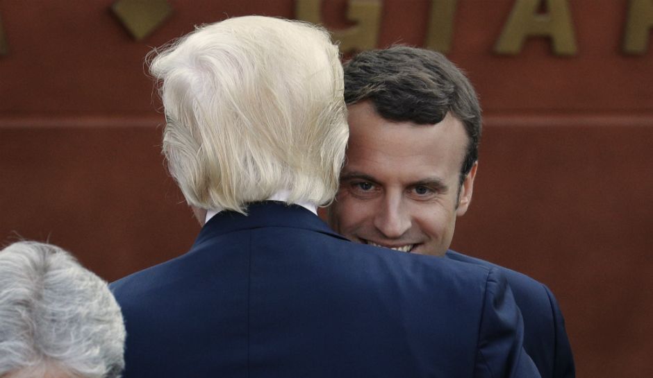 U.S. President Donald Trump and French President Emmanuel Macron share a hug at the Ancient Theatre of Taormina in Taormina Italy