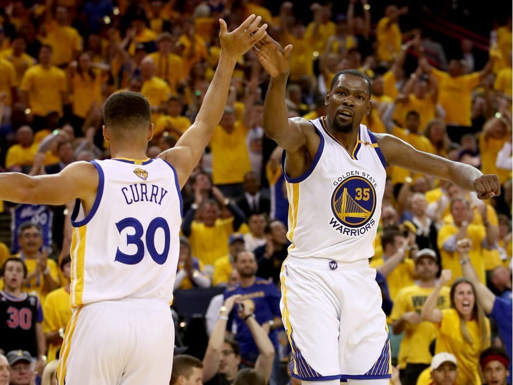 Stephen Curry #30 and Kevin Durant #35 of the Golden State Warriors react to a play against the Cleveland Cavaliers in Game 2 of the 2017 NBA Finals at ORACLE Arena