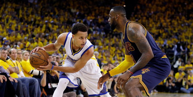 Golden State Warriors guard Stephen Curry left is guarded by Cleveland Cavaliers forward Le Bron James