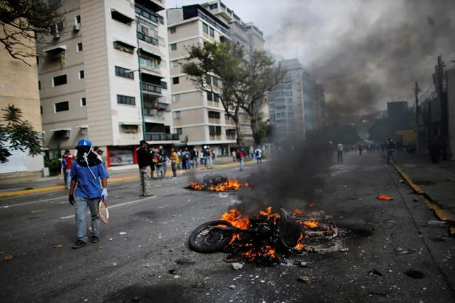 ADDS MOTORCYCLES BELONGED TO NATIONAL GUARD- Two National Guard soldiers&#39 motorcycles burn set on fire by protesters after the soldiers ran from their bikes after they fell during clashes with anti-government protesters in Caracas Venezuela Wedne