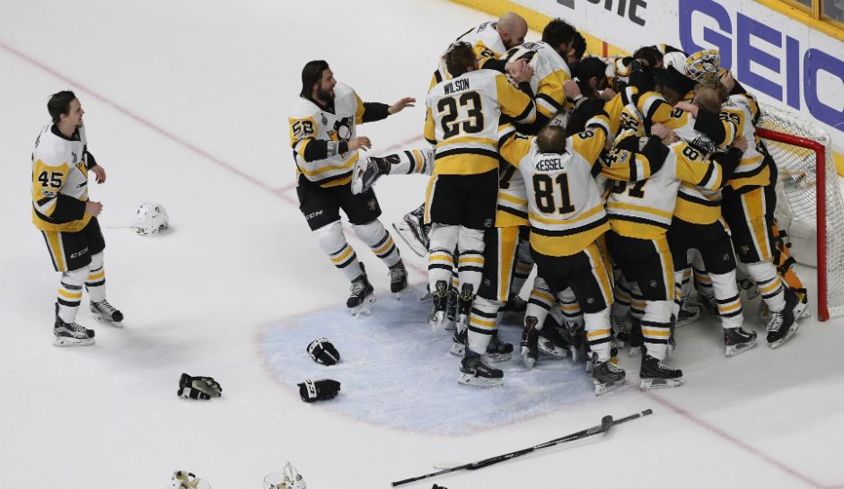 Penguins Players surround goaltender Matt Murray to celebrate winning the Stanley Cup