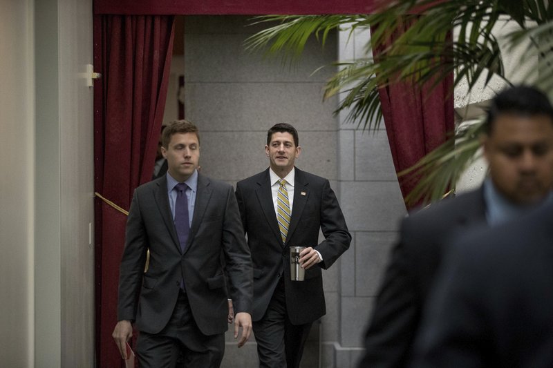 House Speaker Paul Ryan of Wis. center arrives for a GOP caucus meeting on Capitol Hill in Washington Tuesday