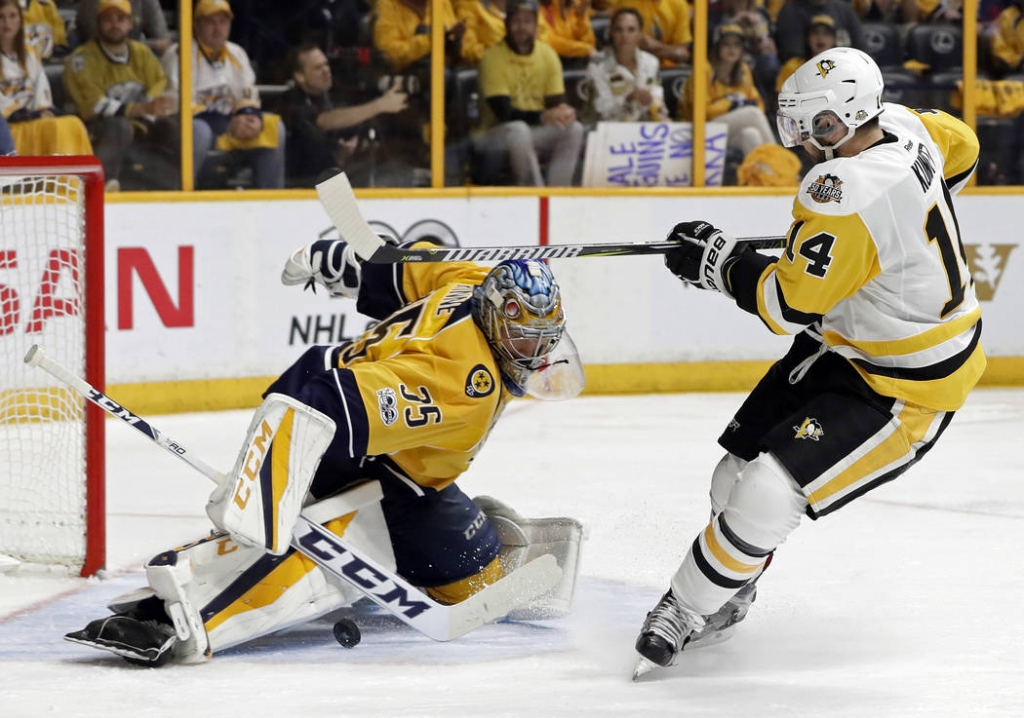 Nashville Predators goalie Pekka Rinne, of Finland stops a shot by Pittsburgh Penguins left wing Chris Kunitz during the second period in Game 4 of the NHL hockey Stanley Cup Finals Mon