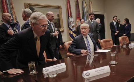 President Donald Trump center waits for Senate Majority Leader Mitch Mc Connell of Ky. left and House Speaker Paul Ryan of Wis. right to take their seats to begin a meeting with House and Senate Leadership in the Roosevelt Room of the White House