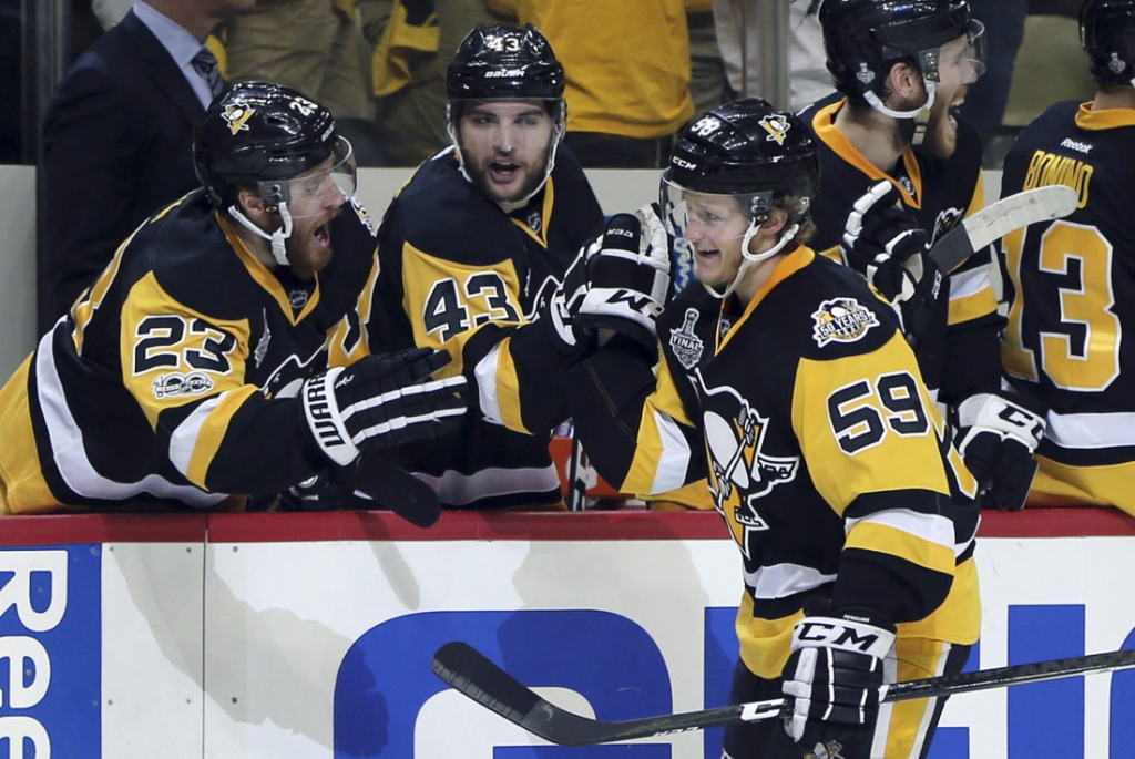 Pittsburgh Penguins&#039 Jake Guentzel celebrates his second goal of the ngiht against the Nashville Predators with teammates Scott Wilson left and Conor Sheary center during the third period in Game 2 of the NHL hockey Stanley Cup Final Wednes