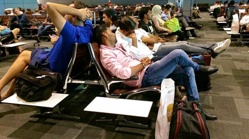 Passengers of cancelled flights wait in Hamad International Airport in Doha Qatar. Qatar's foreign minister says Kuwait is trying to mediate a diplomatic crisis in which Arab countries have cut diplomatic ties and moved to isolate his energy-rich