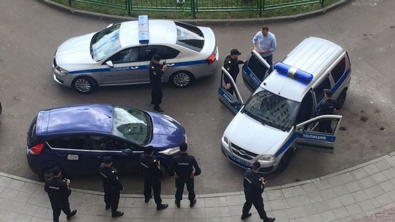 Russian opposition leader is seen getting into a police car as he was detained in front of his home on Monday