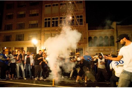 Fans light fireworks on a street in downtown Oakland Calif. after the Golden State Warriors defeated the Cleveland Cavaliers in game 5 of the NBA Finals on Monday