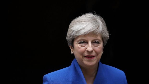 Prime Minister Theresa May leaves Downing Street to go to Buckingham Palace for the Queen's permission to form a UK