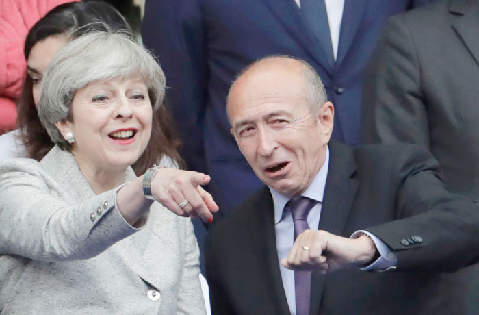 Britain’s Prime Minister Theresa May left gestures as she stands alongside French Interior Minister Gerard Collomb right ahead of the international friendly football match between France and England at The Stade de France Stadium in Saint Denis near