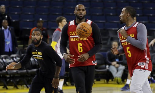 From left Cleveland Cavaliers Kyrie Irving Le Bron James and J.R. Smith work on drills during an NBA basketball practice Wednesday