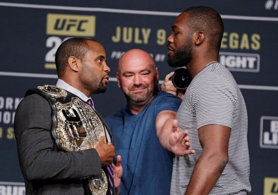 Dana White center stands between Daniel Cormier left