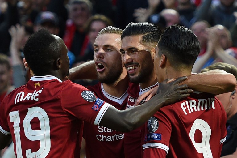 Liverpool's German midfielder Emre Can celebrates with teammates scoring his team's first goal during