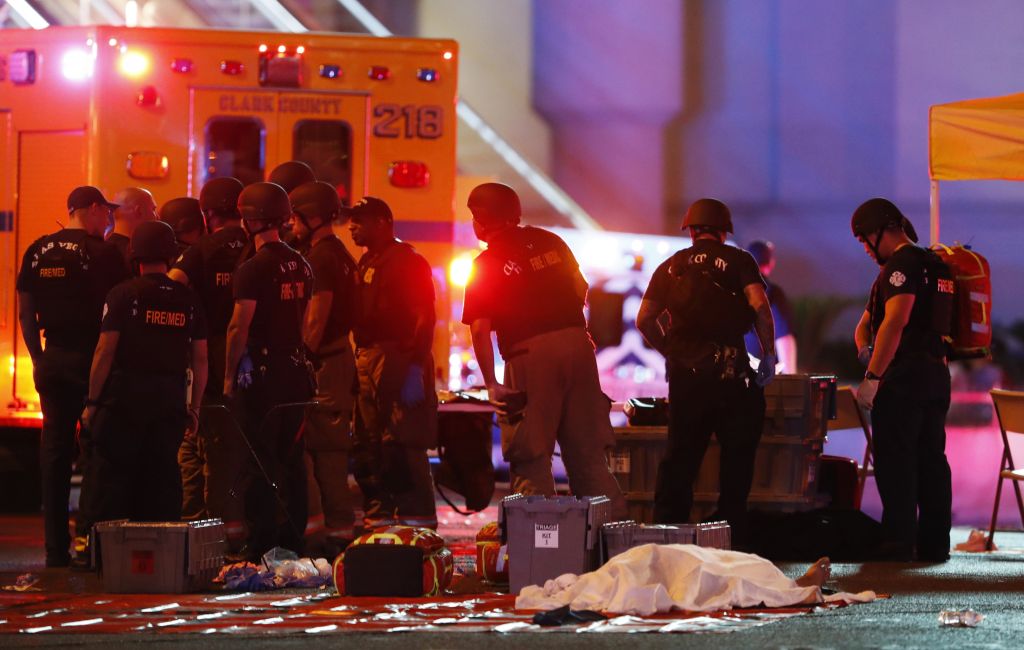 A body is covered with a sheet after a mass shooting at a music festival on the Las Vegas Strip on Sunday