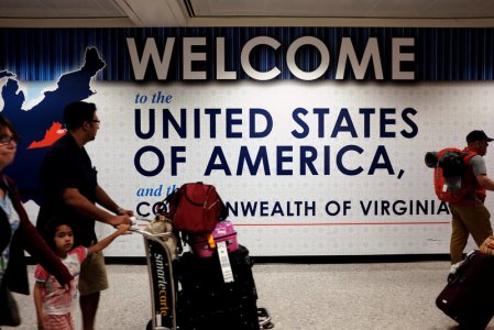 A family exits after clearing immigration and customs at Dulles International Airport in Dulles Virginia