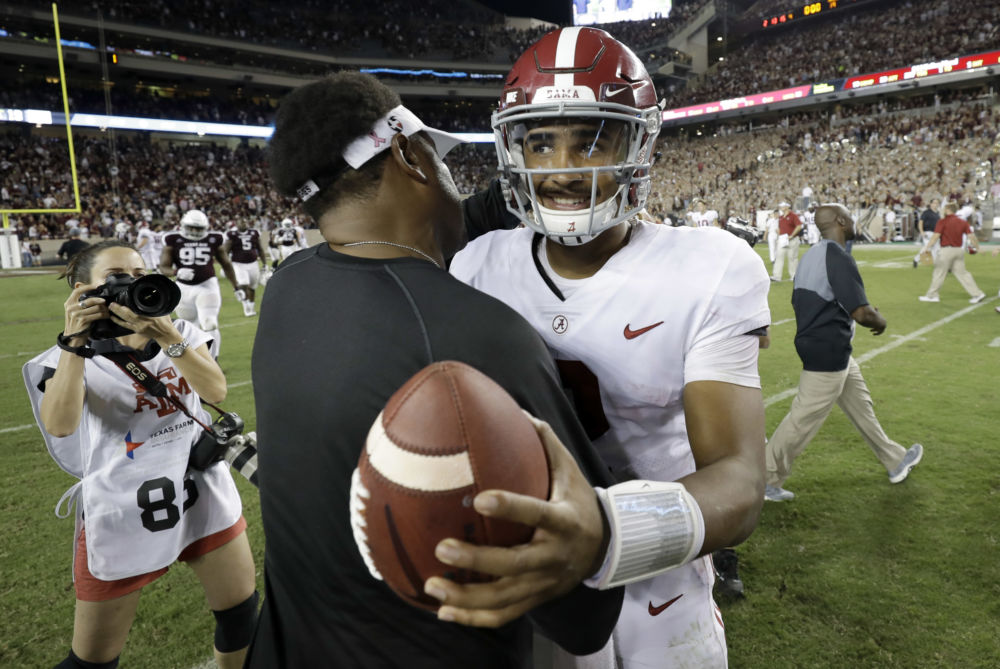 Texas A&M coach Kevin Sumlin left hugs Alabama quarter Jalen Hurts after an NCAA college football game Saturday Oct. 7 2017 in College Station Texas. Alabama won 27-19