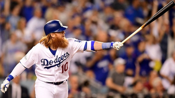 Justin Turner of the Los Angeles Dodgers hits a three-run home run in the first inning against the Arizona Diamondbacks in game one of the National League Division Series at Dodger Stadium