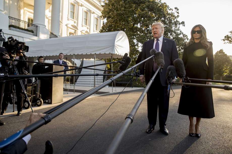 President Donald Trump accompanied by first lady Melania Trump speaks to reporters before boarding Marine One on the South Lawn of the White House in Washington Wednesday Oct. 4 2017 for a short trip to Andrews Air Force Base Md. and then on to La