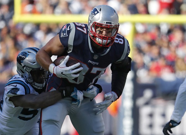 New England Patriots tight end Rob Gronkowski tries to break a tackle against the Carolina Panthers during an NFL football game at Gillette Stadium in Foxborough Mass. Sunday Oct. 1 2017