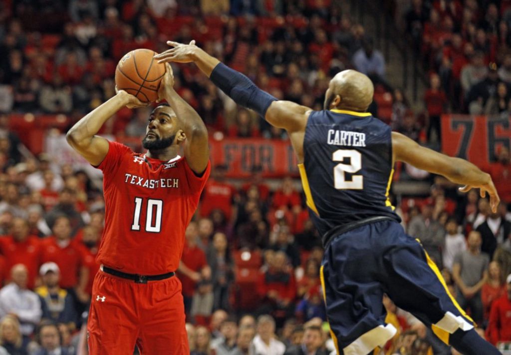 Texas Tech's Niem Stevenson shoots the ball around West Virginia's Jevon Carter during the second half of an NCAA college basketball game Saturday Jan. 13 2018 in Lubbock Texas