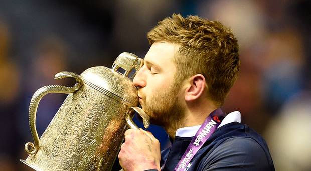 Scotland's Finn Russell celebrates with the Calcutta Cup after the win over England