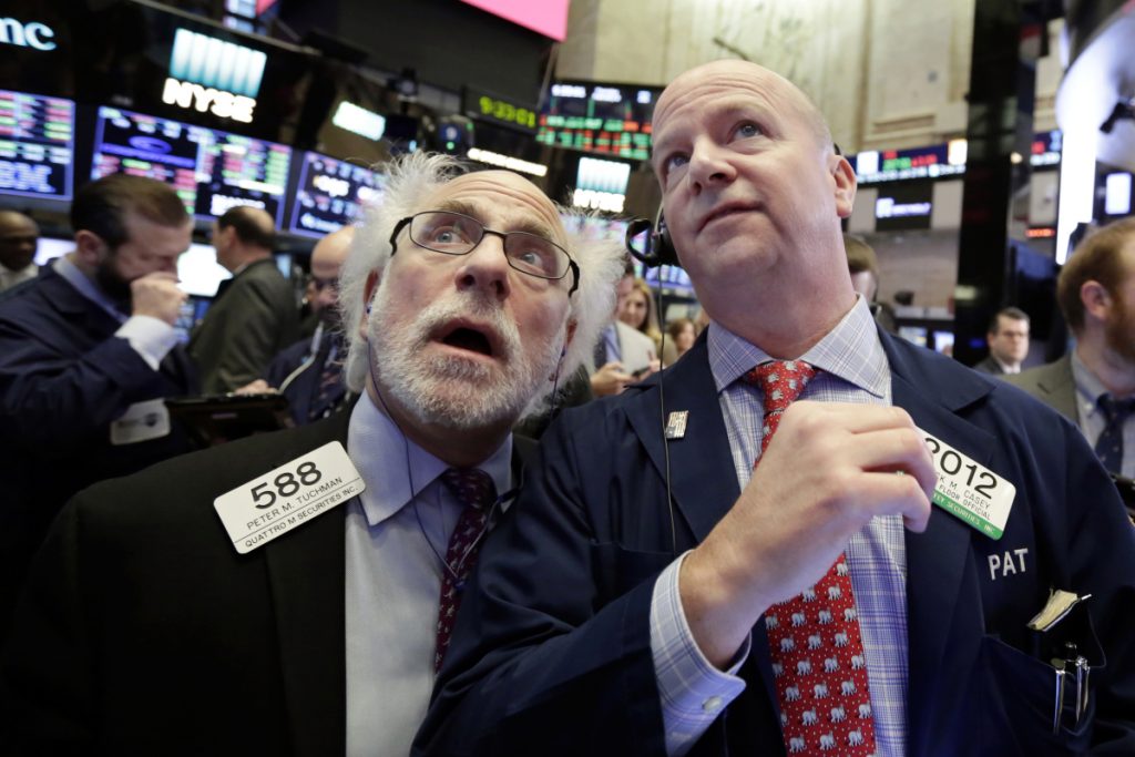 Traders Peter Tuchman left and Patrick Casey work on the floor of the New York Stock Exchange on Thursday