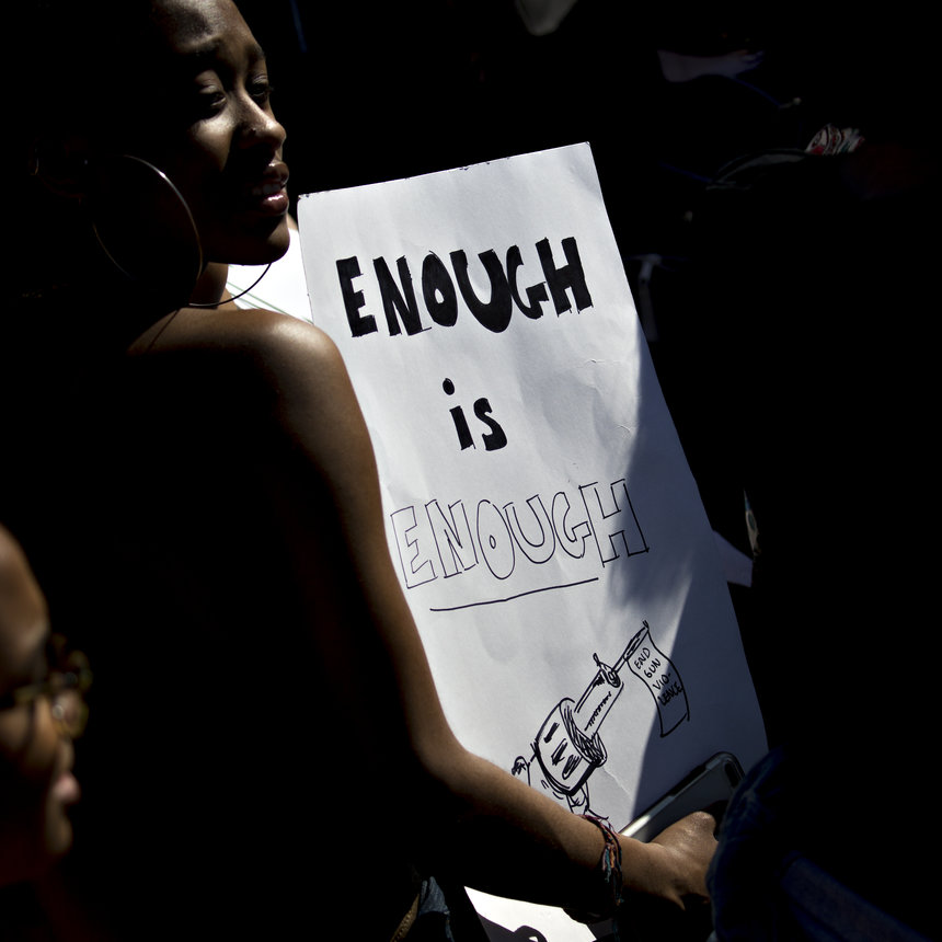 A demonstrator holds a sign reading 'Enough is Enough&#x27 while protesting gun violence outside the White House in Washington D.C