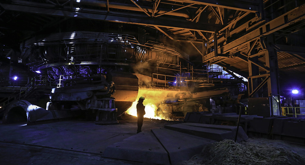 A steelworker watches as molten steel pours from one of the Blast Furnaces during'tapping at the British Steel- Scunthorpe plant in north Lincolnshire north east England