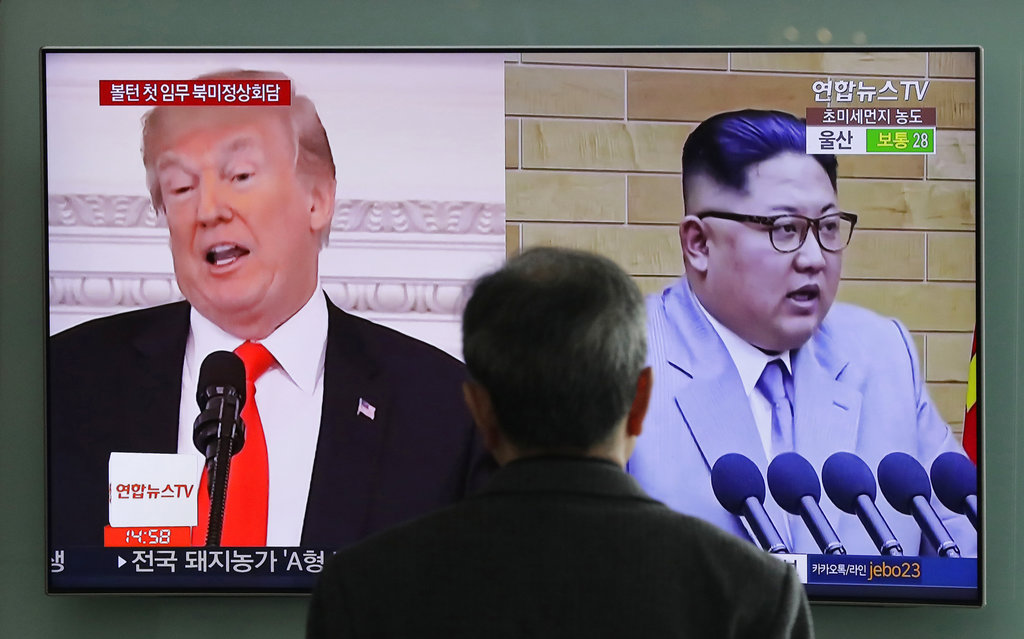 A man watches a TV screen showing file footages of U.S. President Donald Trump left and North Korean leader Kim Jong Un right during a news program at the Seoul Railway Station in Seoul South Korea. (AP