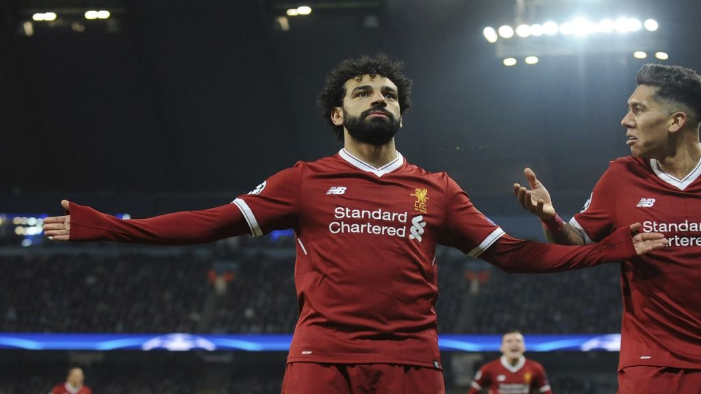 Liverpool's Mohamed Salah left celebrates with Roberto Firmino after scoring his side's first goal during the Champions League quarterfinal second leg match against Manchester City at the Etihad stadium in Manchester England Tuesday April