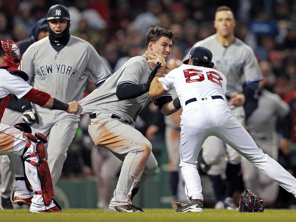 Boston Red Sox relief pitcher Joe Kelly fights with New York Yankees first baseman Tyler Austin after hitting him with a pitch along with catcher Christian Vazquez during the seventh inning of the MLB game at Fenway Park on Wednesda