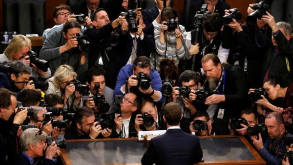 Reuters Caption Mark Zuckerberg is surrounded by members of the media as he arrives
