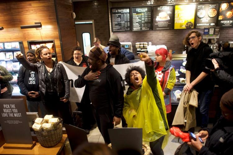 Protestors demonstrate inside a Center City Starbucks where two black men were arrested in Philadelphia Pennsylvania U.S