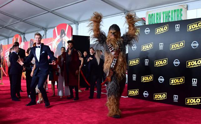 Actor Joonas Suotamo, who plays Chewbacca reacts as a person in a Chewbacca suit gestures on the red carpet at the premiere of the film `Solo A Star Wars Story` in Hollywood California on 10 May 2018