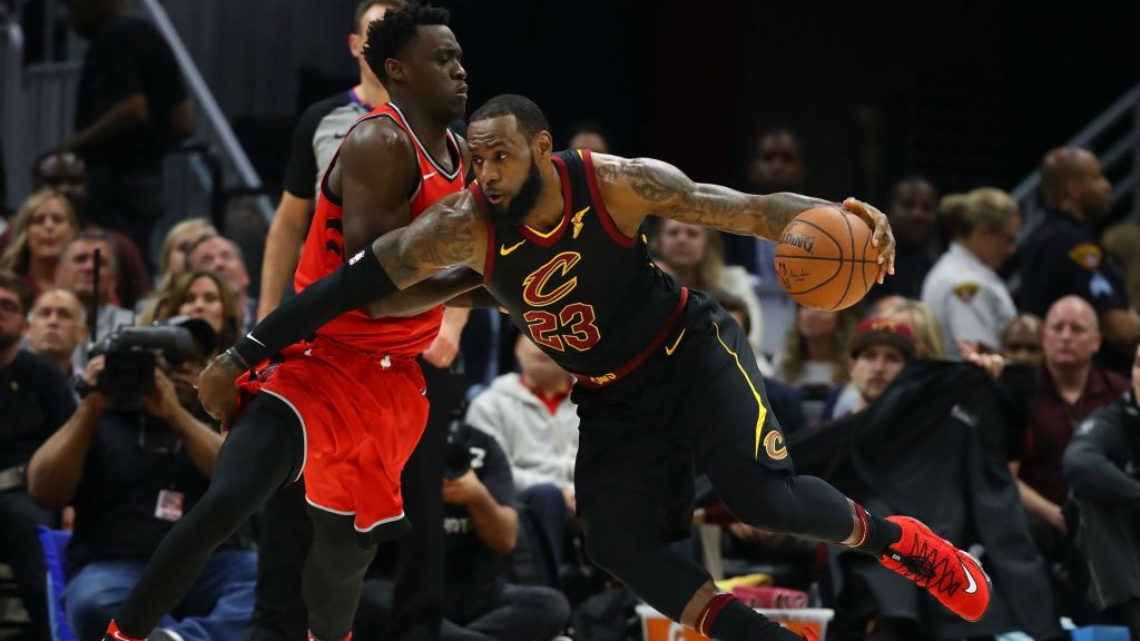 Cavs forward Le Bron James looks to drive past Raptors forward Pascal Siakam