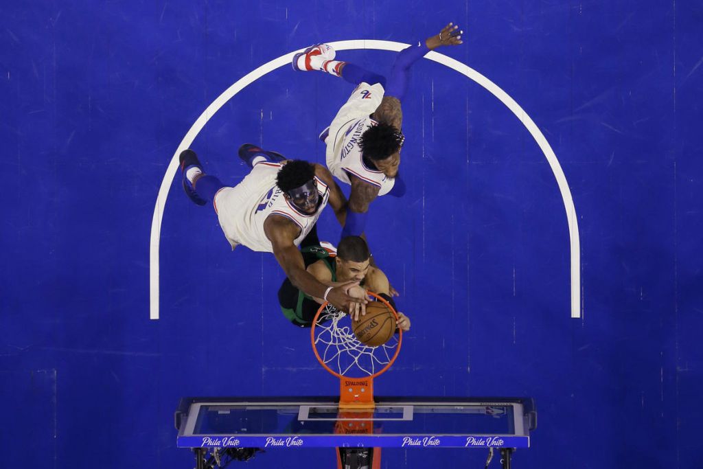 Boston Celtics&#039 Jayson Tatum center dunks against Philadelphia 76ers&#039 Joel Embiid left and Robert Covington during the first half of Game 3 of an NBA basketball second-round playoff series Saturday