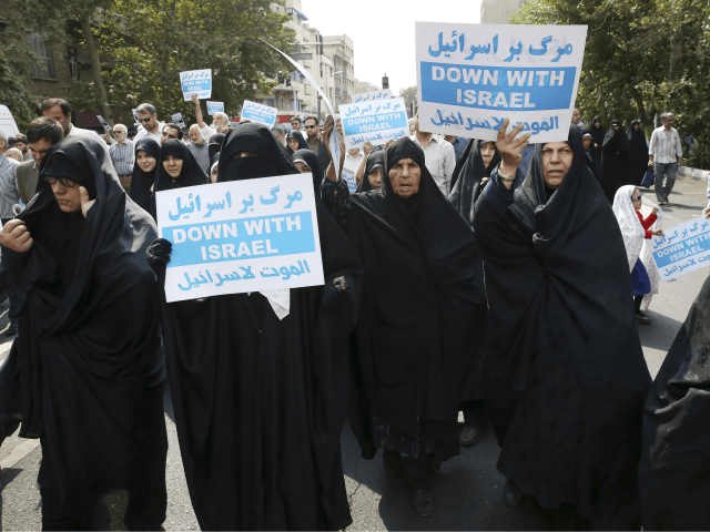 Iranian women hold anti Israeli placards at a protest after Friday prayer service in Tehran Iran Friday Sept. 18 2015. Hundreds of worshipers staged an anti Israeli protest for its response to Palestinians protest against unusual numbers of Jewish vis