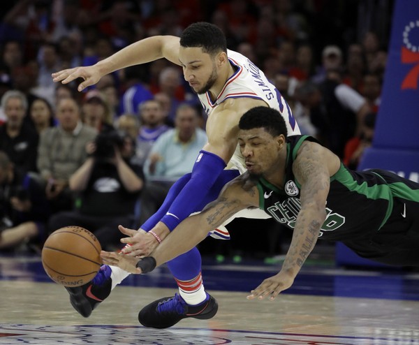 Boston Celtics Marcus Smart right and Philadelphia 76ers Ben Simmons chase after a loose ball during the first half of Game 3 of an NBA basketball second-round playoff series Monday