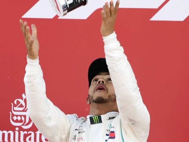 Soaking it in Mercedes&#039 British driver Lewis Hamilton tosses his trophy on the podium after winning the Spanish Formula One Grand Prix race at the Circuit de Catalunya in Montmelo