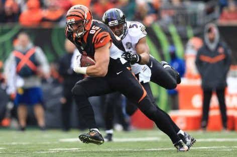 Dalton in coat, stands around during practice _ a step back