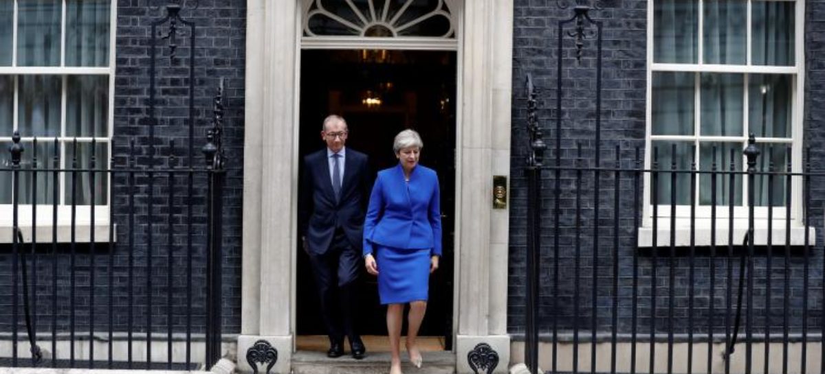 Tottering Theresa May names new UK Cabinet as critics circle